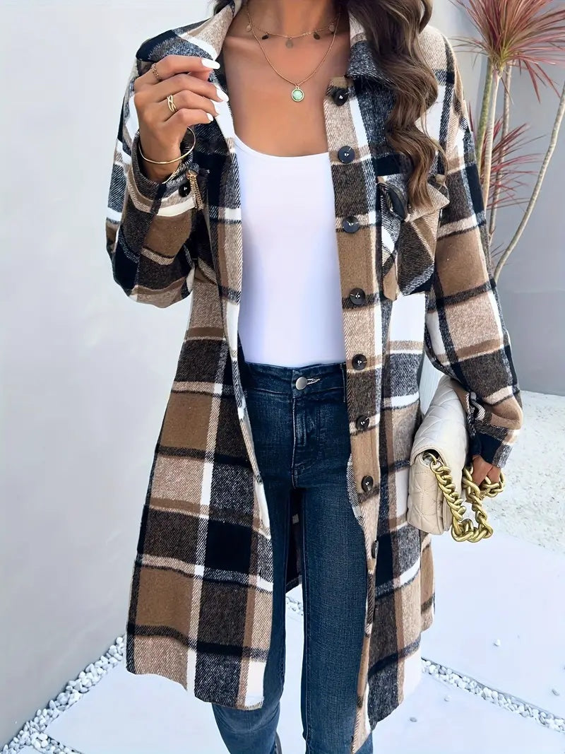 Person wearing a plaid coat over a white shirt and jeans, holding a gold handbag.